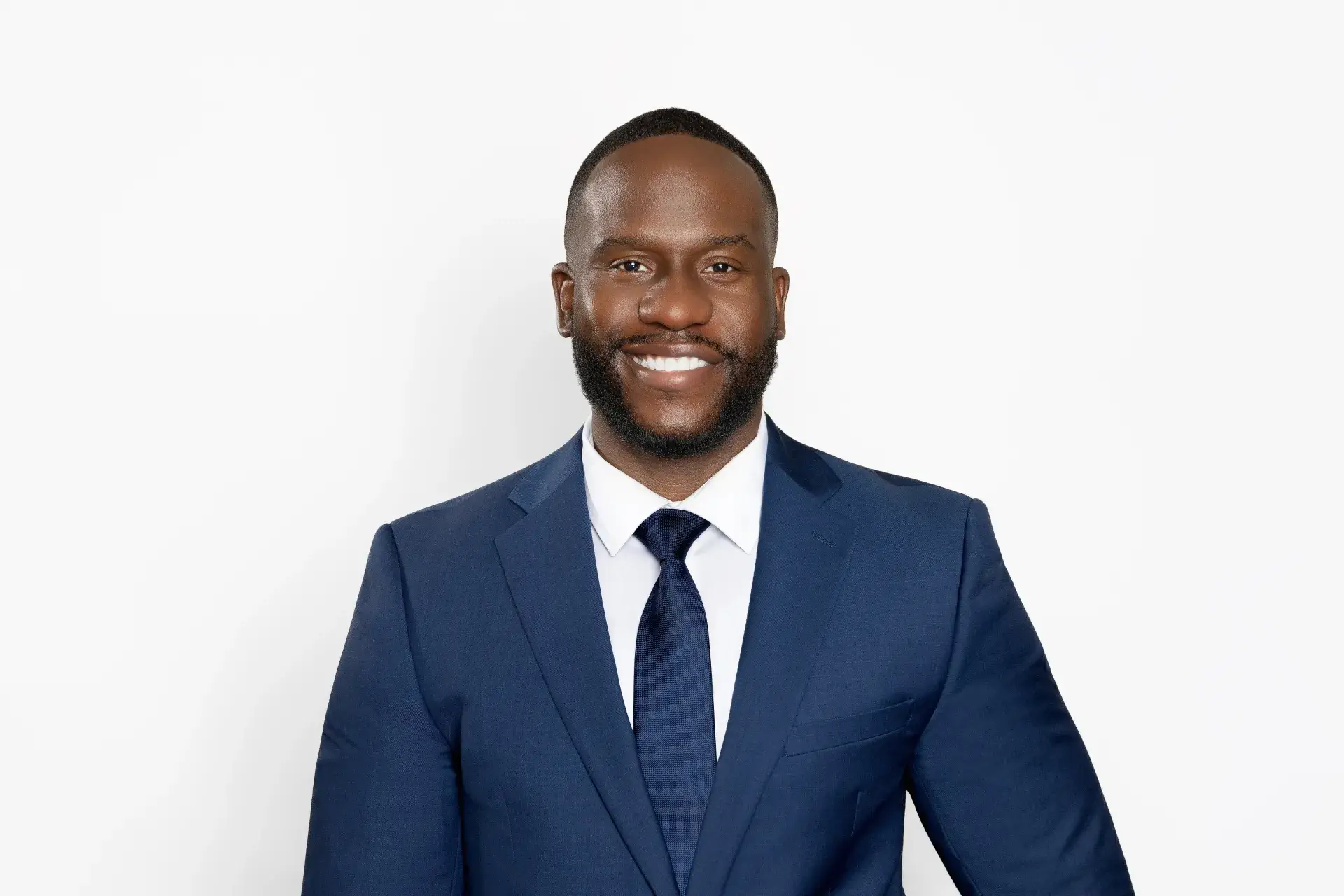 Chester Uzoma, partner attorney at Uzoma Sudarma in Sugar Land, Texas, in a navy suit.